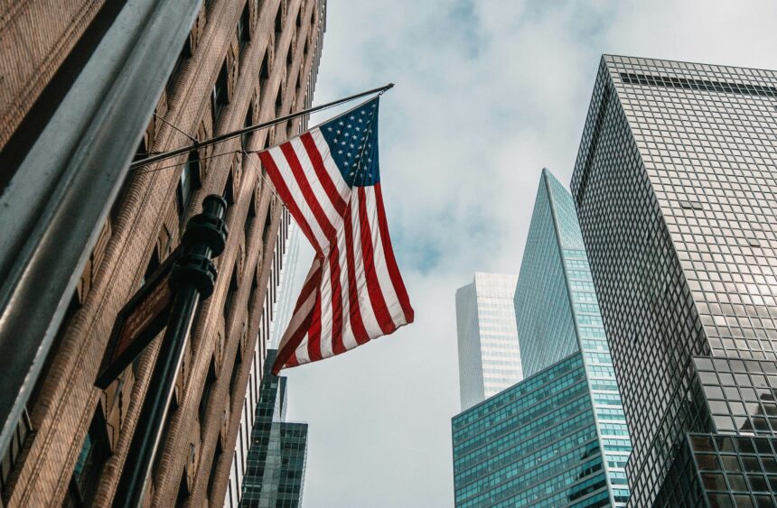 American flag hanging between tall city buildings in a USA downtown area