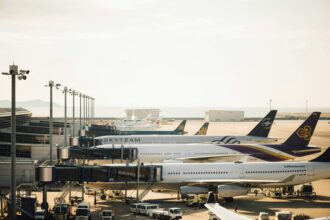 Row of international airline planes parked at airport gates showing the best airlines for international travel