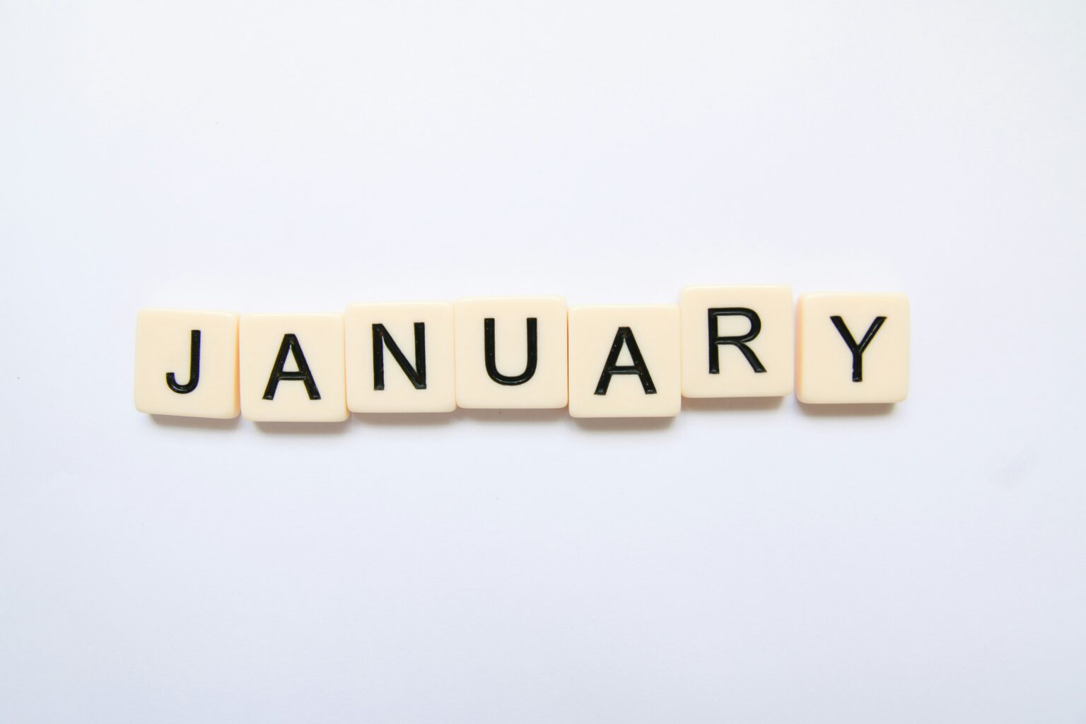 Best places to travel in January shown by the word January spelled in letter tiles