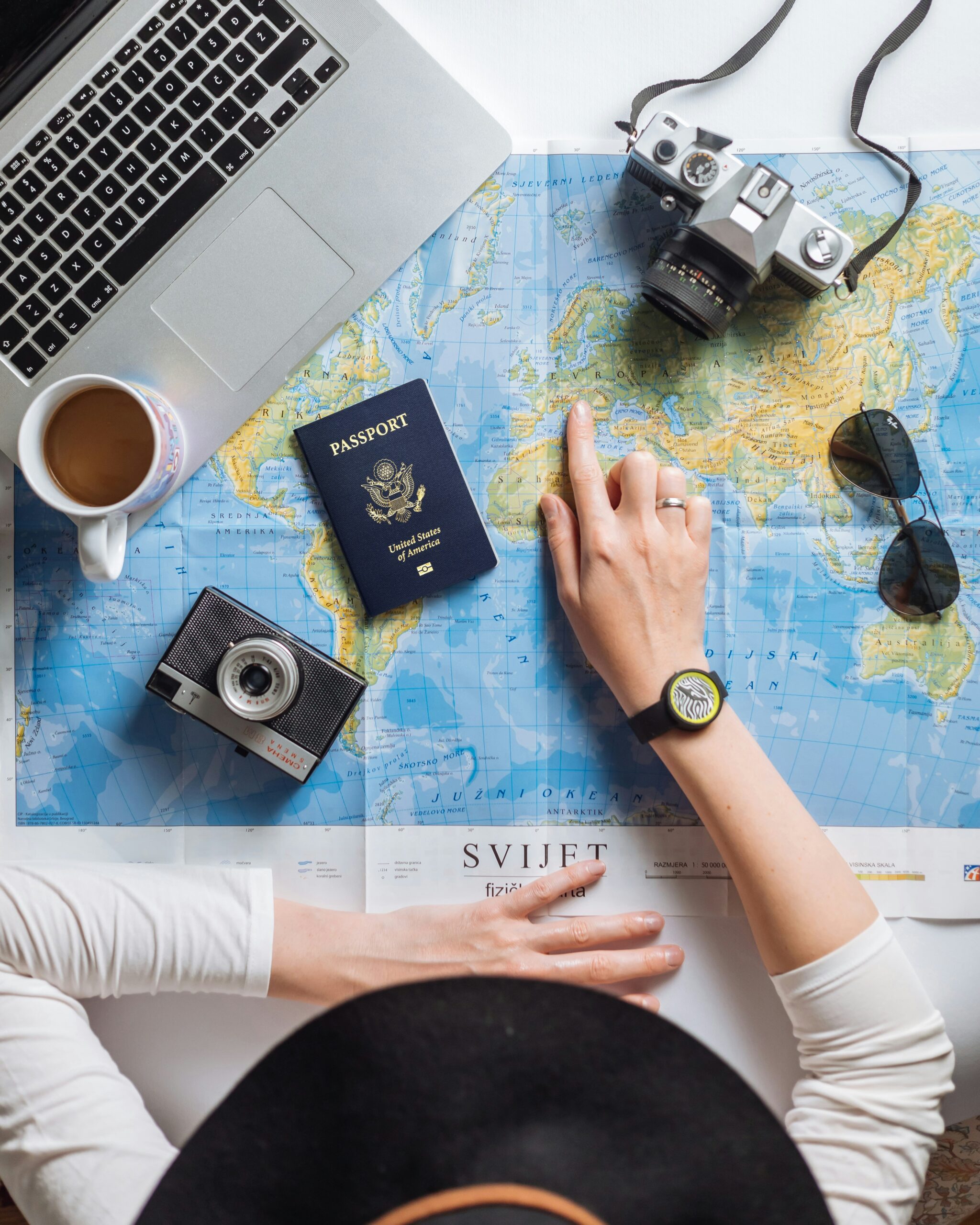 Traveler using a laptop to research cool travel blogs