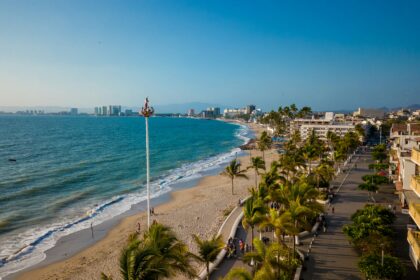 Coastal city beach view with palm trees and ocean for Costa Careyes Mexico.