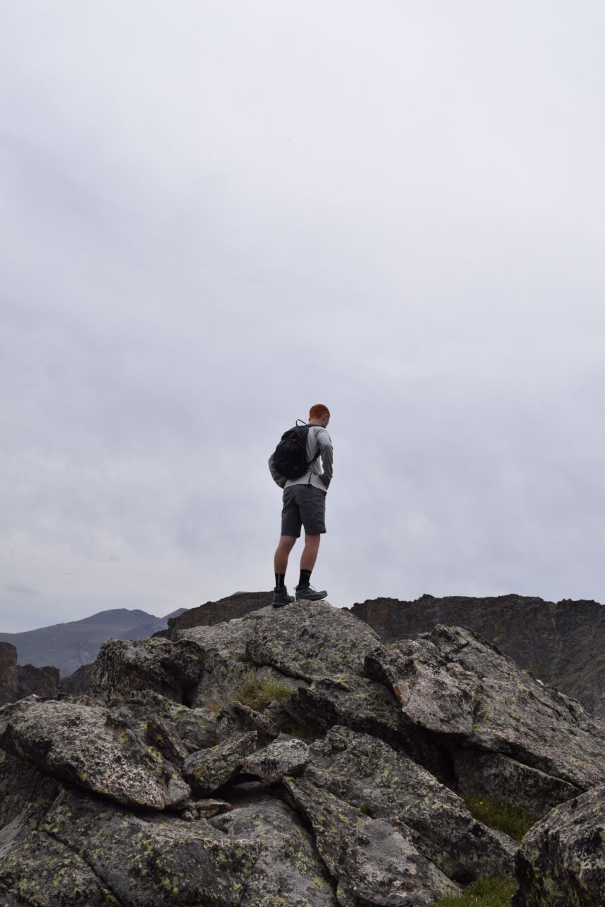 Best hiking trails in Colorado shown by an alpine lake below rugged mountain peaks