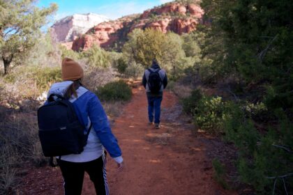 Planning a Sedona hiking trip for beginners shown by a marked trail winding through red rock country