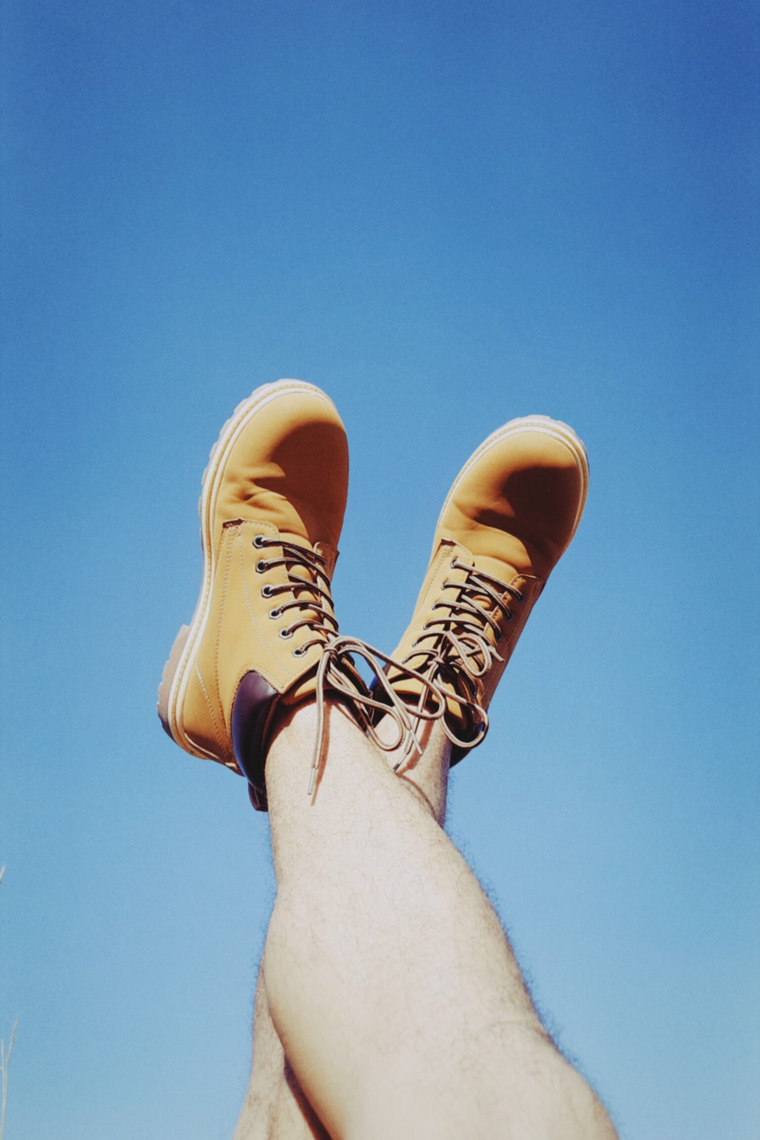 Cheap hiking boots shown as a well-worn pair of budget boots on a dirt trail