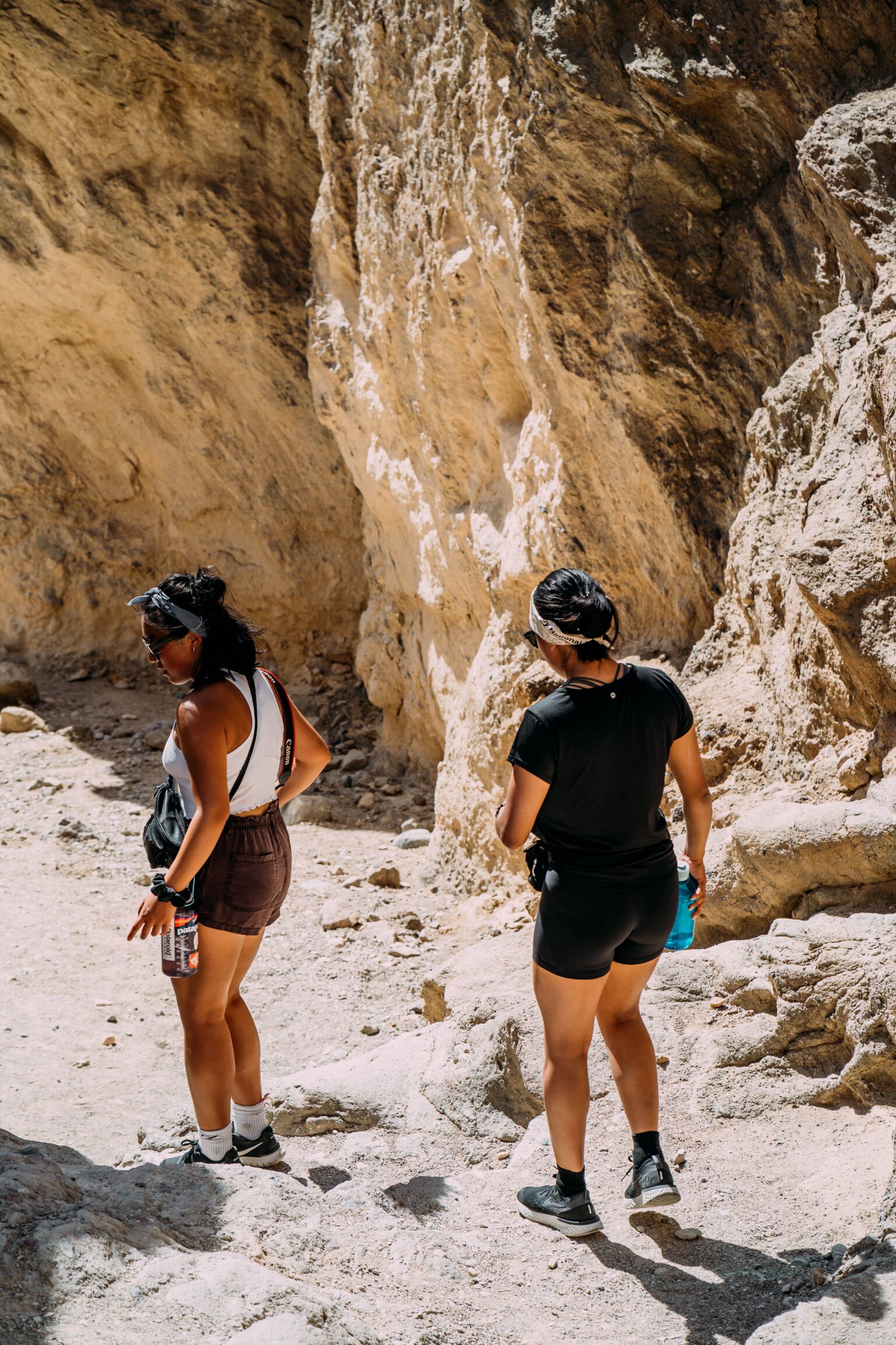 Hiking clothes for women shown by a hiker in layered outdoor clothing on a mountain trail